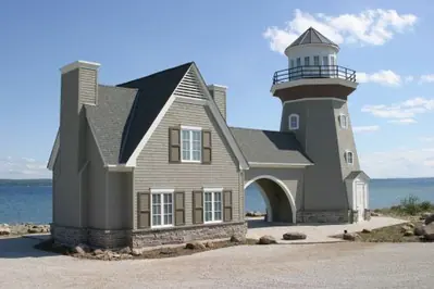 Lighthouse cottage at Cobble Beach on a limestone foundation course above Georgian Bay