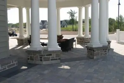 Paver terrace and coursed limestone column bases on the Cobble Beach clubhouse portico