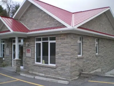 The Ebel Quarries office faced in coursed limestone under a red steel roof