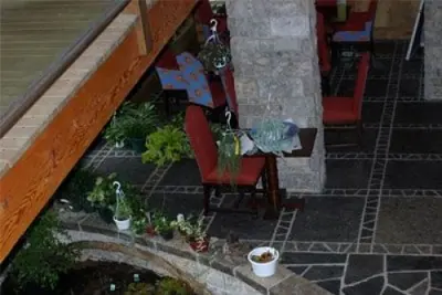 Random broken flagstone floor and limestone wall inside E'Terra Inn
