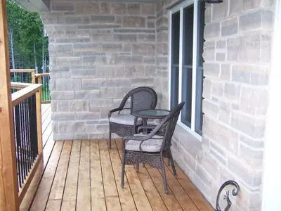 Coursed limestone wall along the veranda of a Wiarton-area home