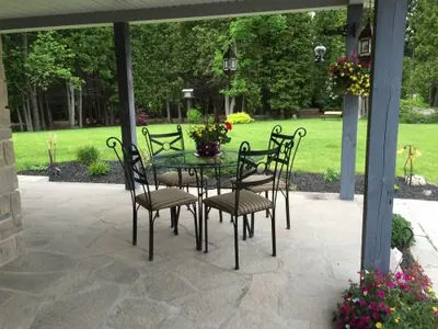 Random flagstone patio under a covered porch at a Wiarton-area home