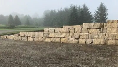 Armour stone retaining wall built from stacked blocks