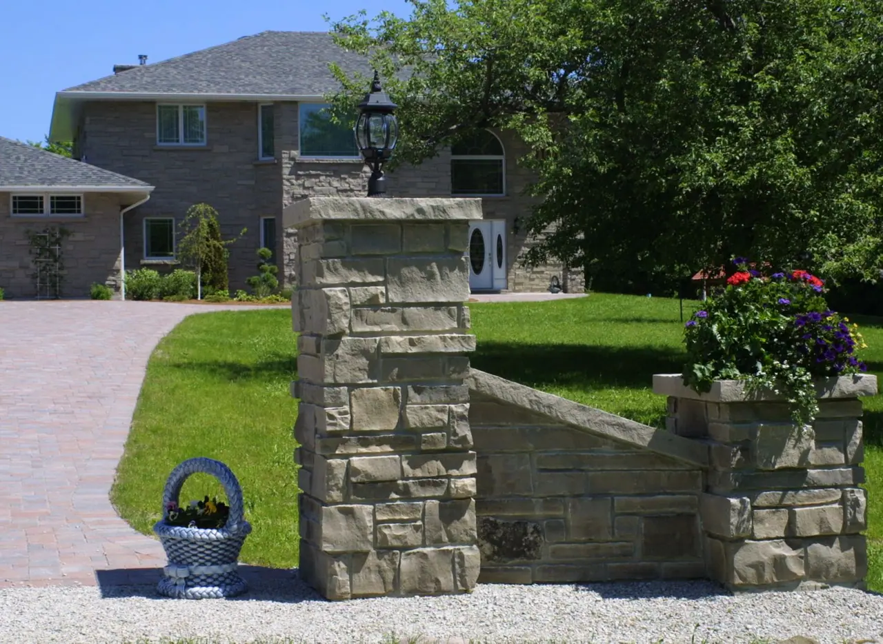 Coursed limestone gate post finished with a limestone cap