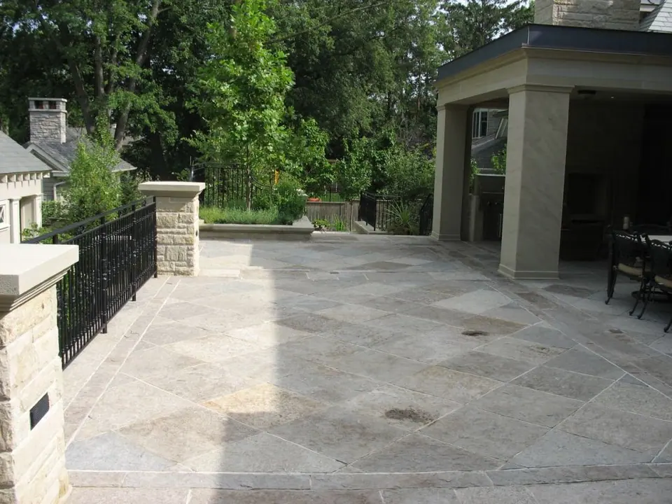 Square cut limestone flagstone pavers laid in a patterned patio installation