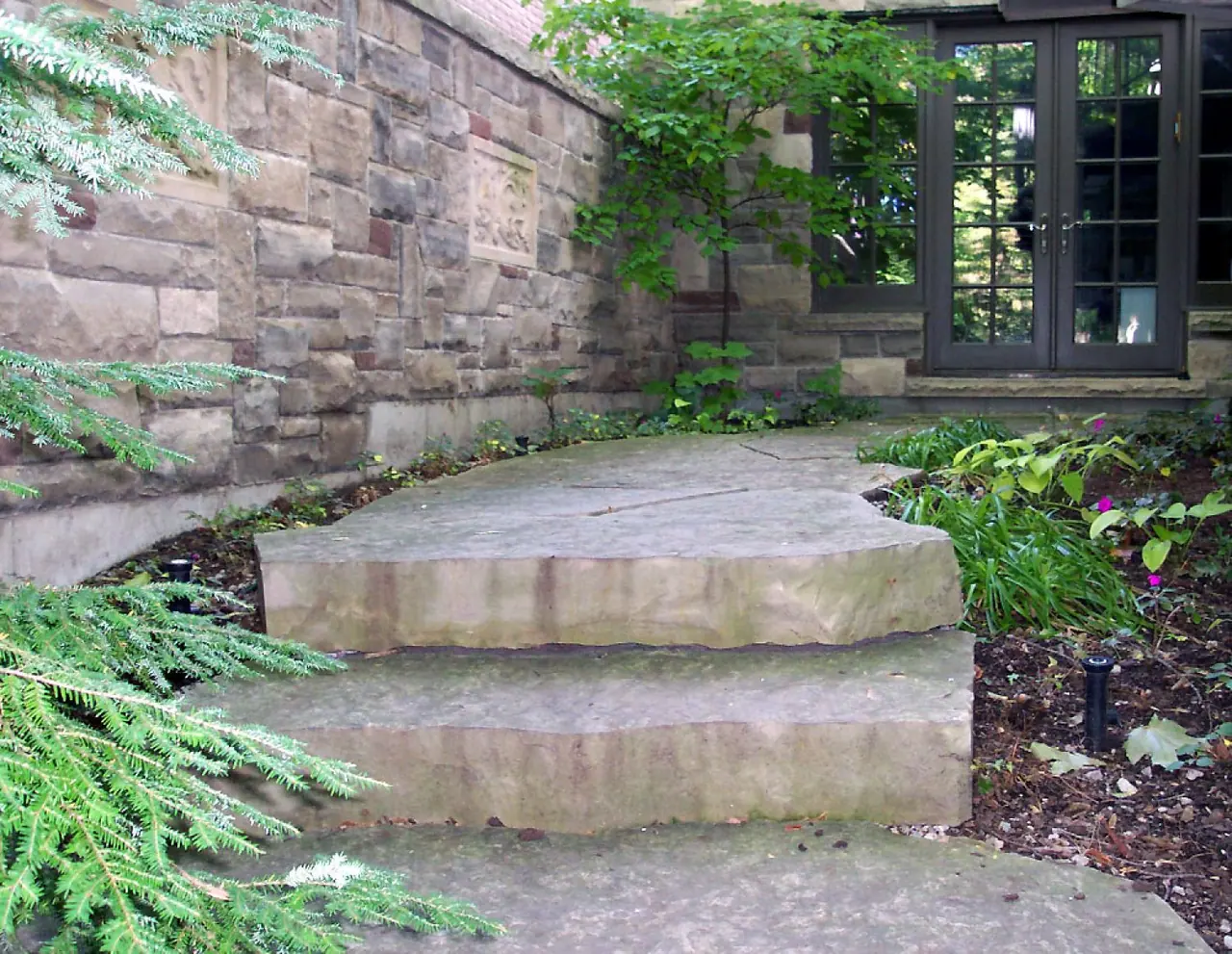 Large random limestone slabs laid as garden steps