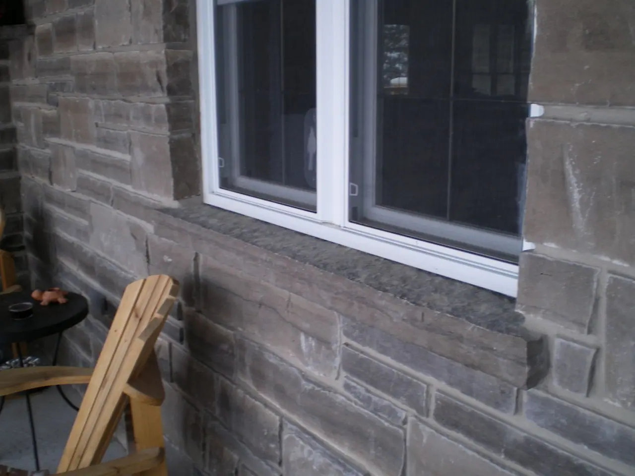 Limestone window sill installed beneath a window
