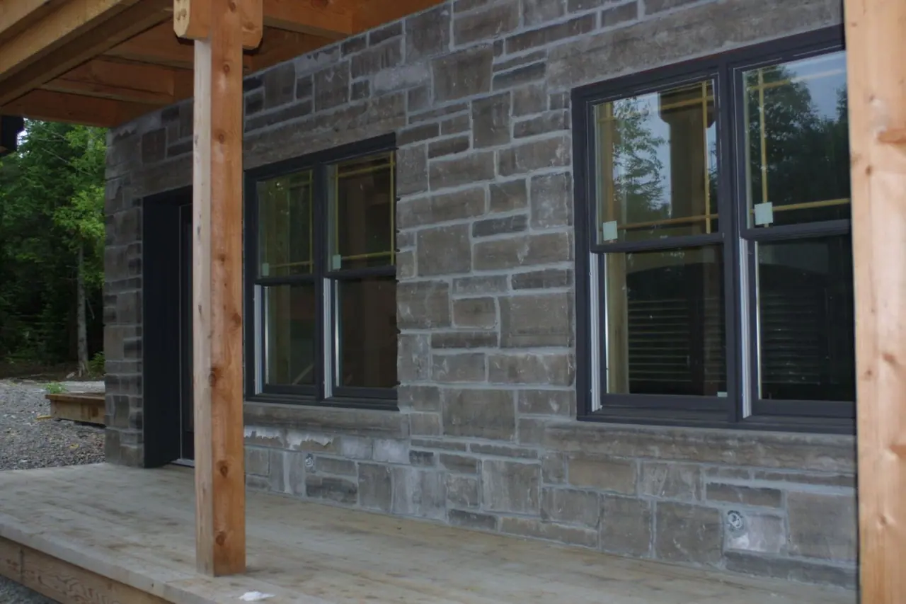 Limestone window sills set in a coursed limestone wall